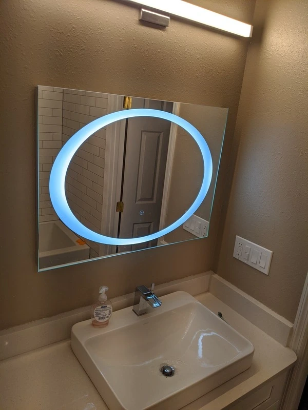 Modern bathroom vanity upgrade with vessel sink, wall-mounted LED mirror, updated faucet, textured wall finish, and clean lighting for a polished bathroom refresh.